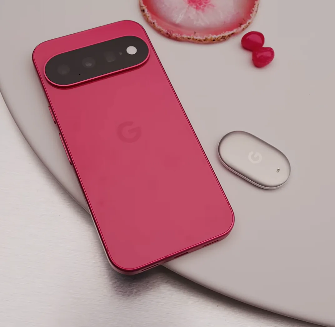 Google Pixel phone beside a compact Google tracker accessory