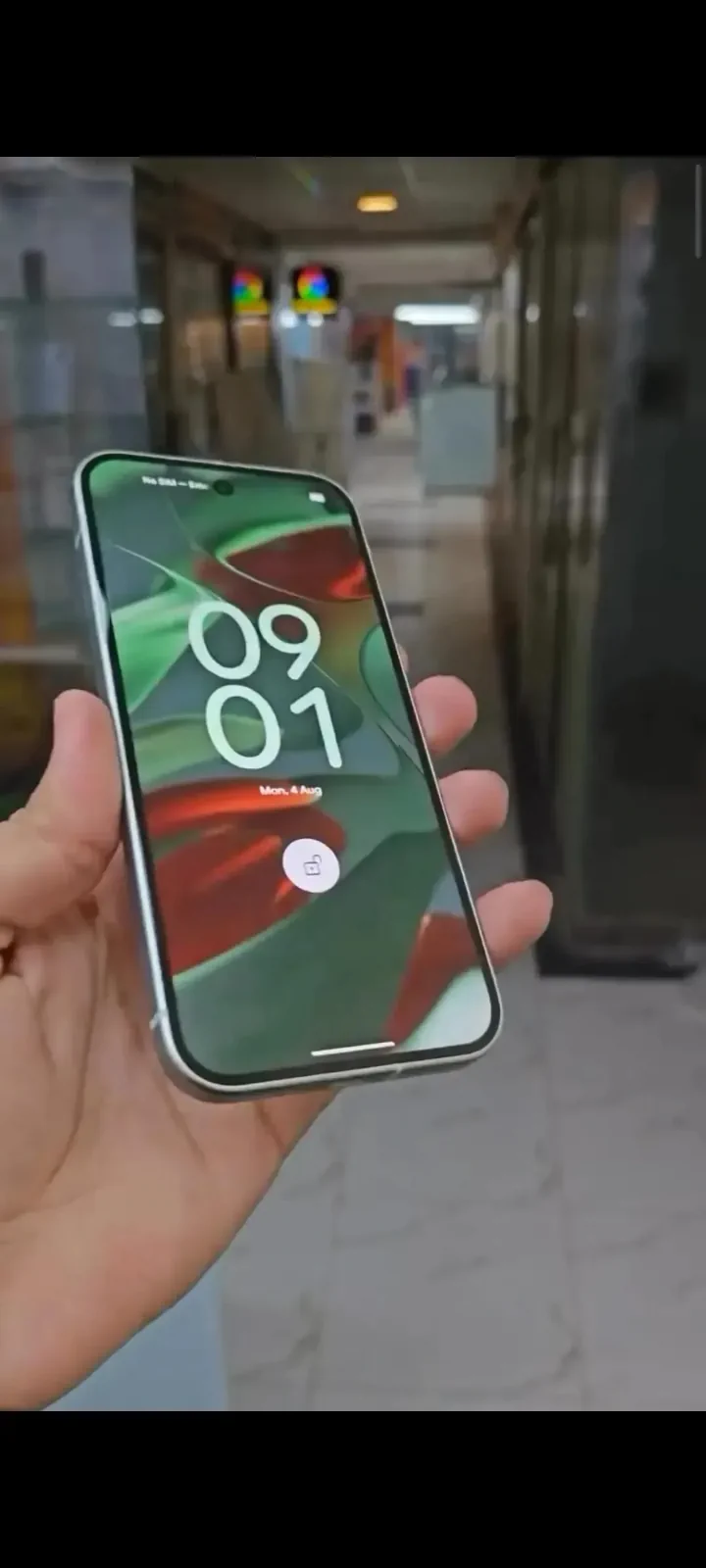 Google Pixel 10a held in hand showing its 6.3-inch display and clean front design