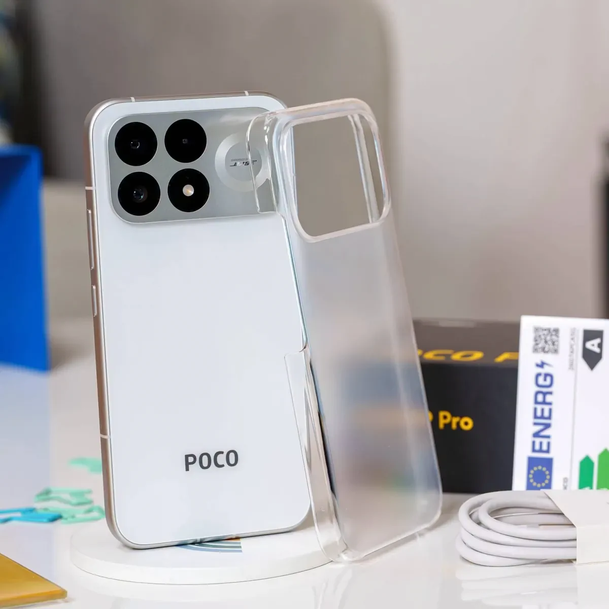 POCO F9 Pro shown with its protective case, box and charging cable