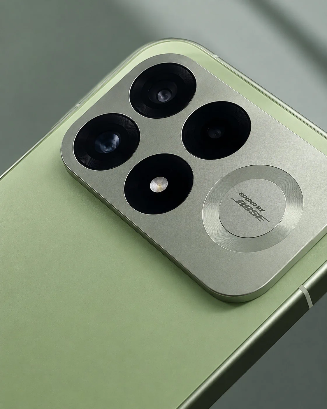 Close-up of the REDMI K100 Pro camera module showing three lenses and Sound by Bose branding