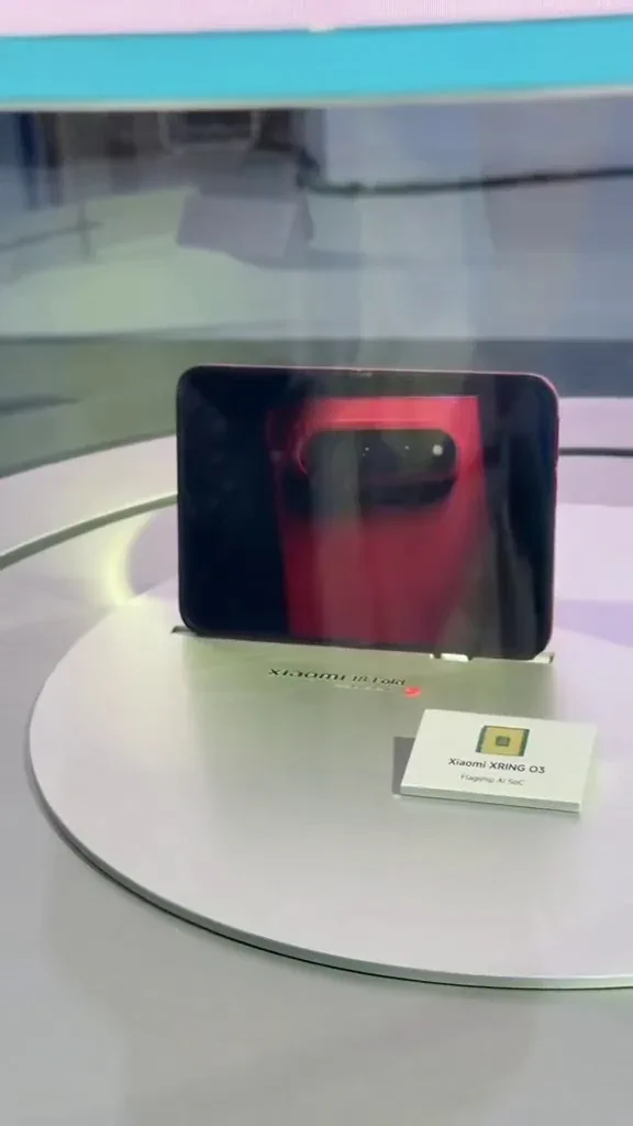 Xiaomi 18 Fold displayed beside an XRing O3 flagship AI SoC placard